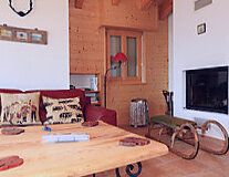 a living area with wooden wheels in a room
